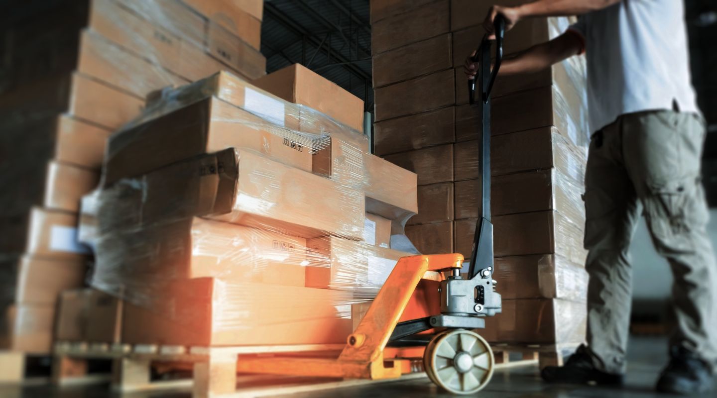 Berryman worker with pallet lift moves palletized inventory as part of B2B Fulfillment services
